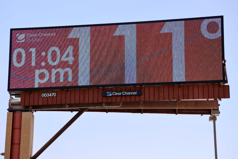 Billboard displays temperature of 111 degrees in Phoenix, AZ during record-breaking heat dome, July 2023.